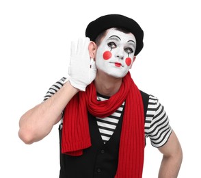 Photo of Mime artist showing hand to ear gesture on white background