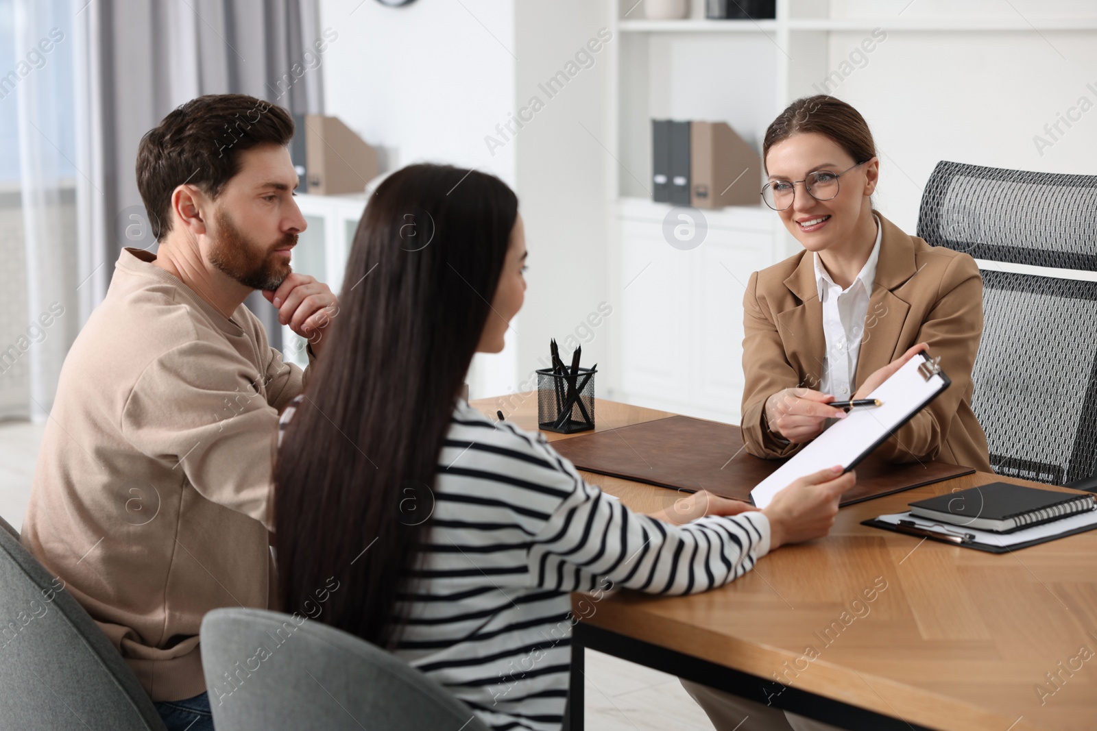 Photo of Couple having meeting with lawyer in office