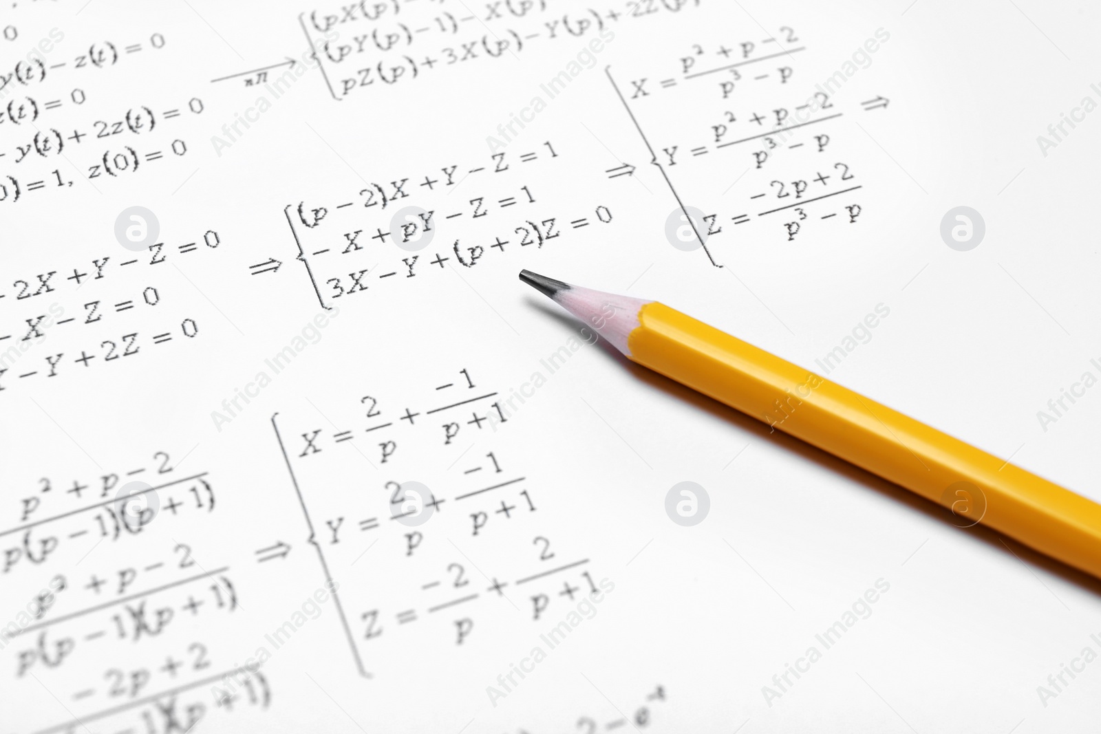 Photo of Sheet of paper with mathematical formulas and pencil, closeup