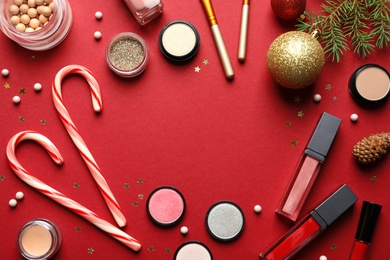 Photo of Flat lay composition with makeup products and Christmas decor on color background. Space for text