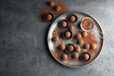 Photo of Flat lay composition with tasty chocolate truffles on grey background, space for text