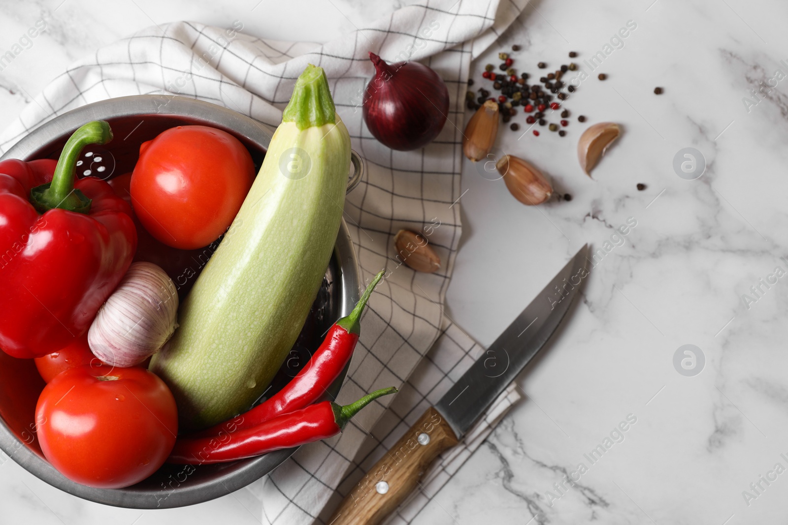 Photo of Fresh vegetables for ratatouille on white marble table, flat lay. Space for text