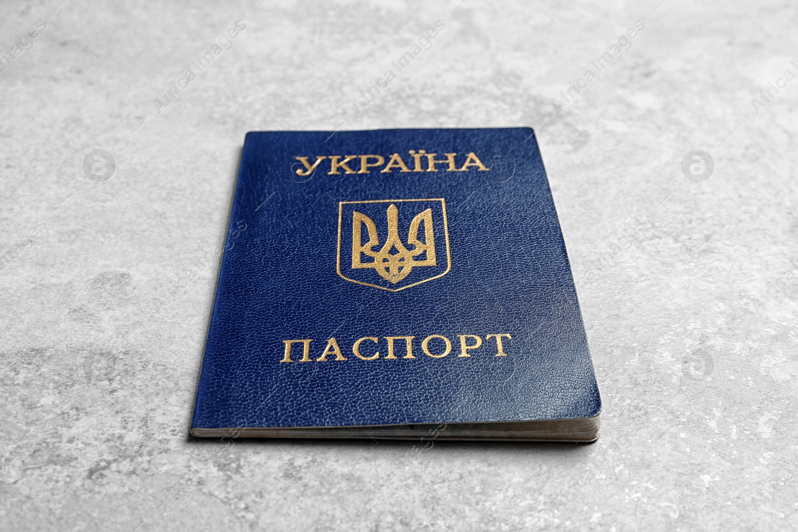 Photo of Ukrainian internal passport on grey background, closeup