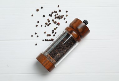 Photo of Pepper shaker on white wooden table, top view