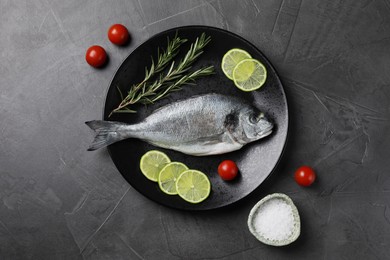 Fresh dorado fish, lime, tomatoes and rosemary on grey table, top view