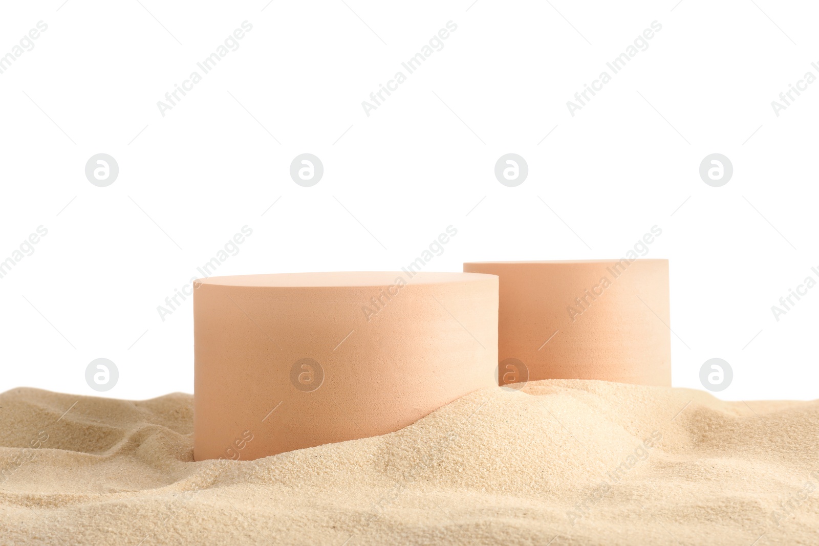 Photo of Presentation of product. Different podiums on sand against white background