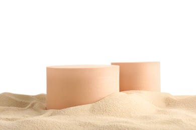 Photo of Presentation of product. Different podiums on sand against white background