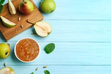 Photo of Tasty homemade pear jam and fresh fruits on light blue wooden table, flat lay. Space for text