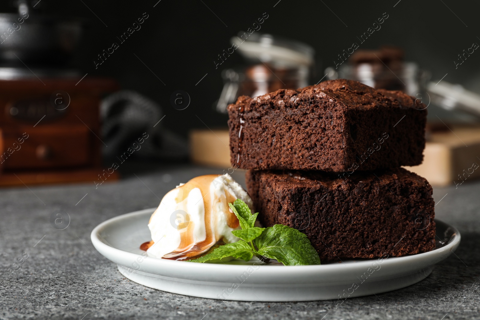 Photo of Plate with fresh brownies and ice-cream on table, space for text. Delicious chocolate pie