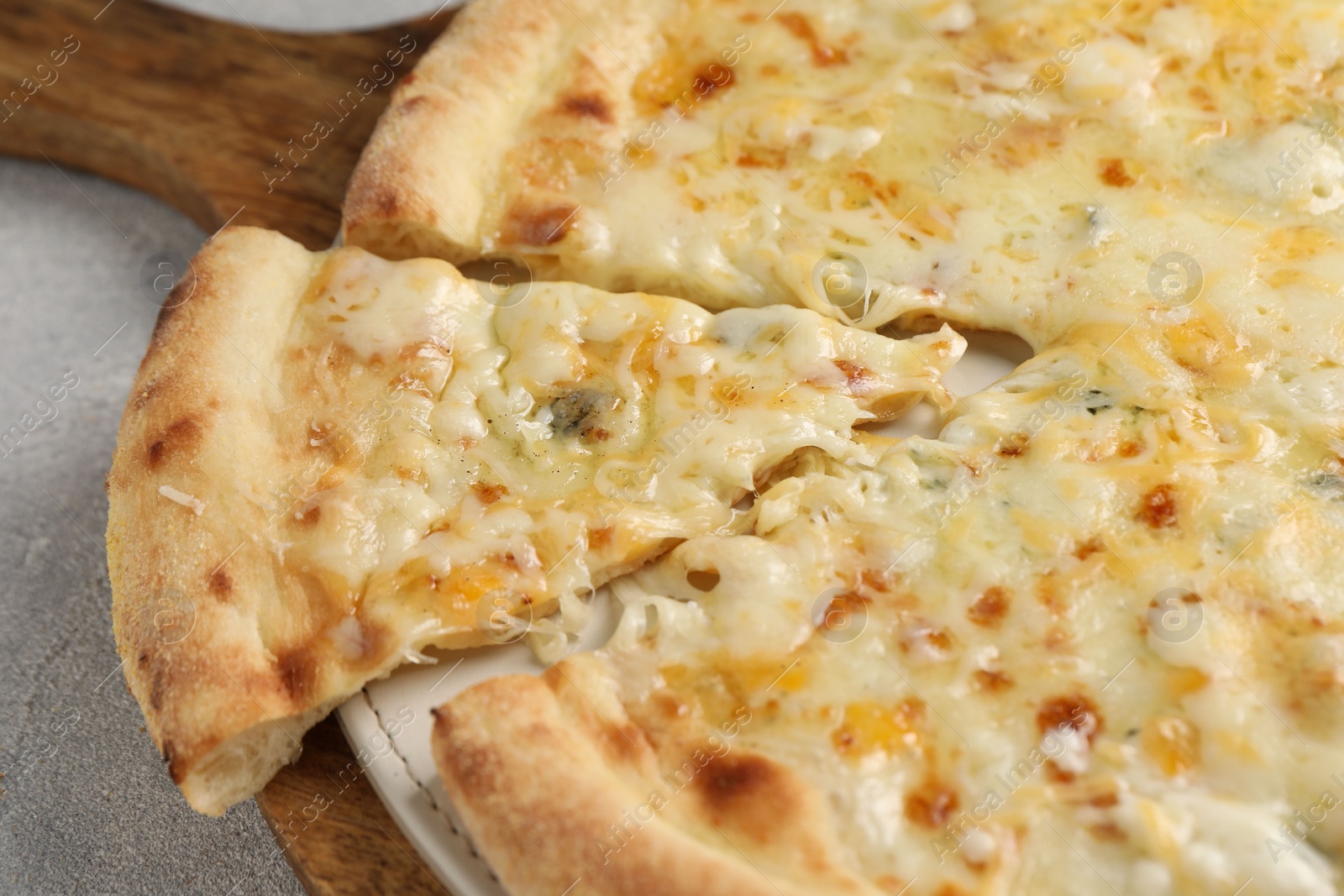 Photo of Delicious cheese pizza on light grey table, closeup