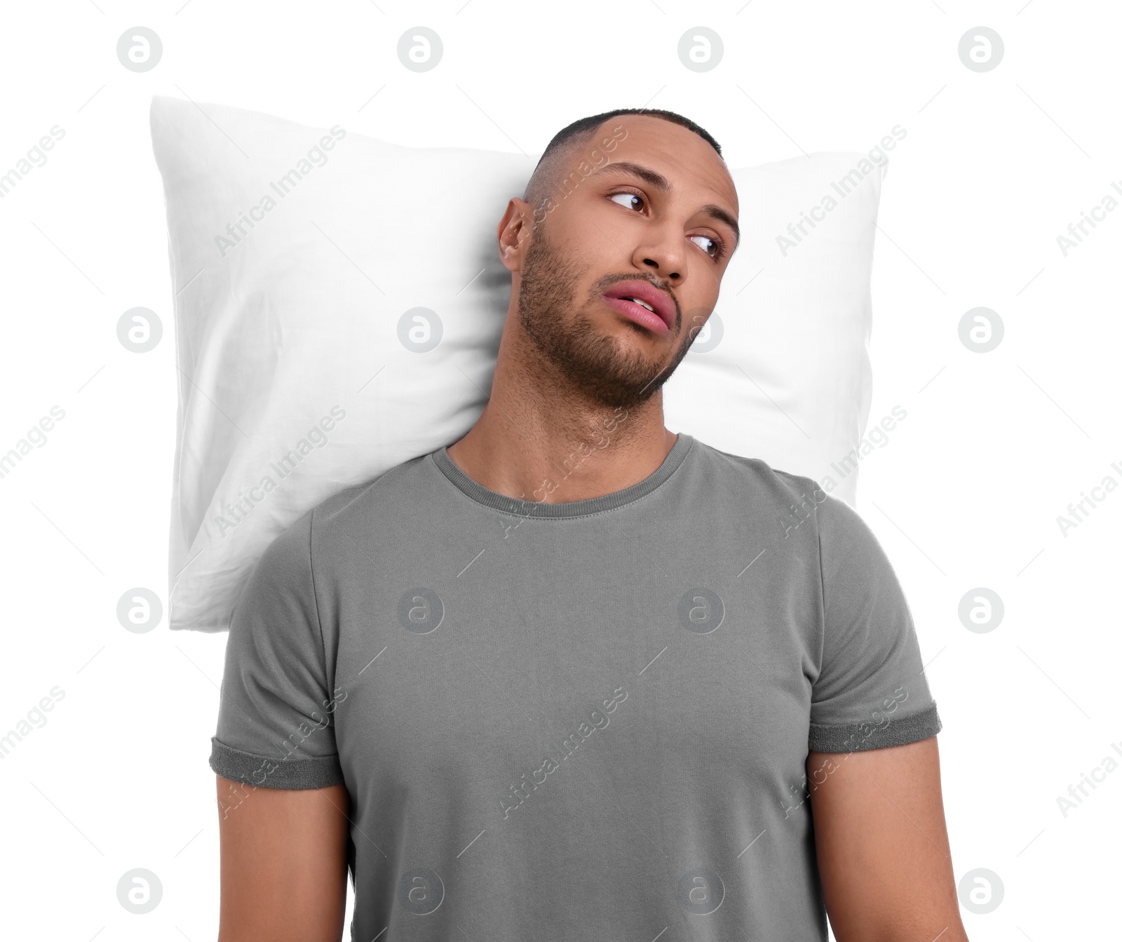 Photo of Tired man with pillow on white background. Insomnia problem