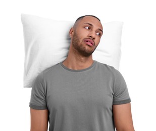 Photo of Tired man with pillow on white background. Insomnia problem
