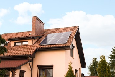 House with installed solar panels on roof. Alternative energy