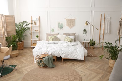 Modern bedroom with beautiful fresh house plants