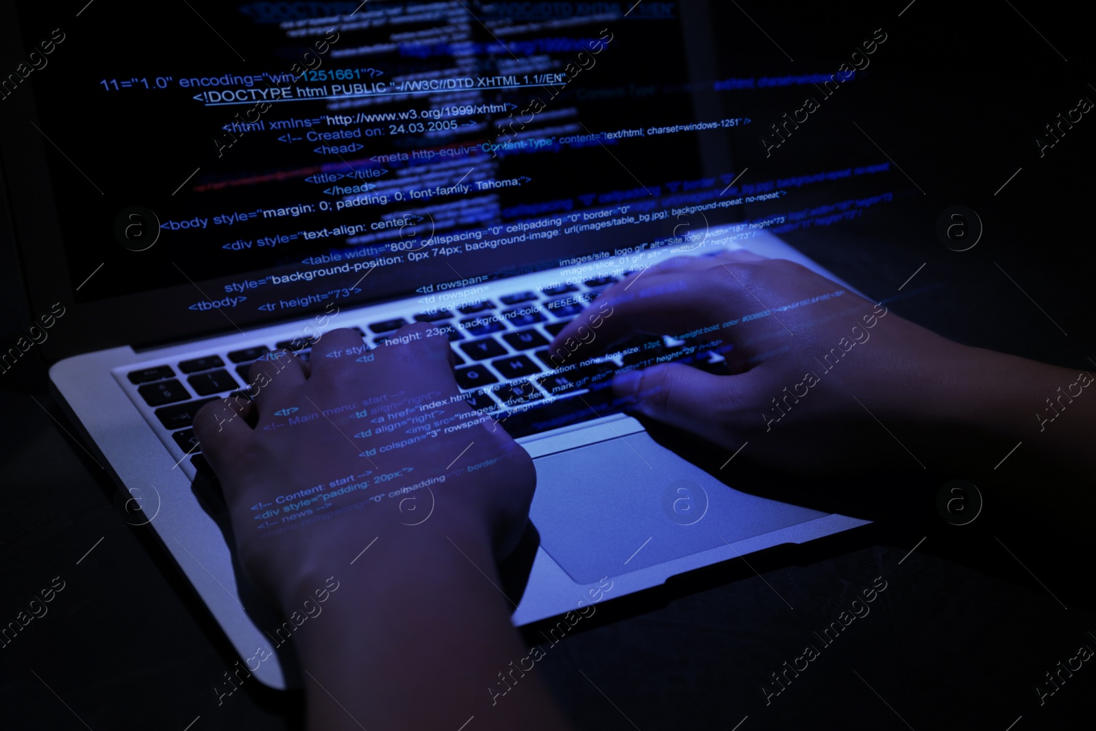 Image of Hacker working with laptop at table, closeup. Cyber attack