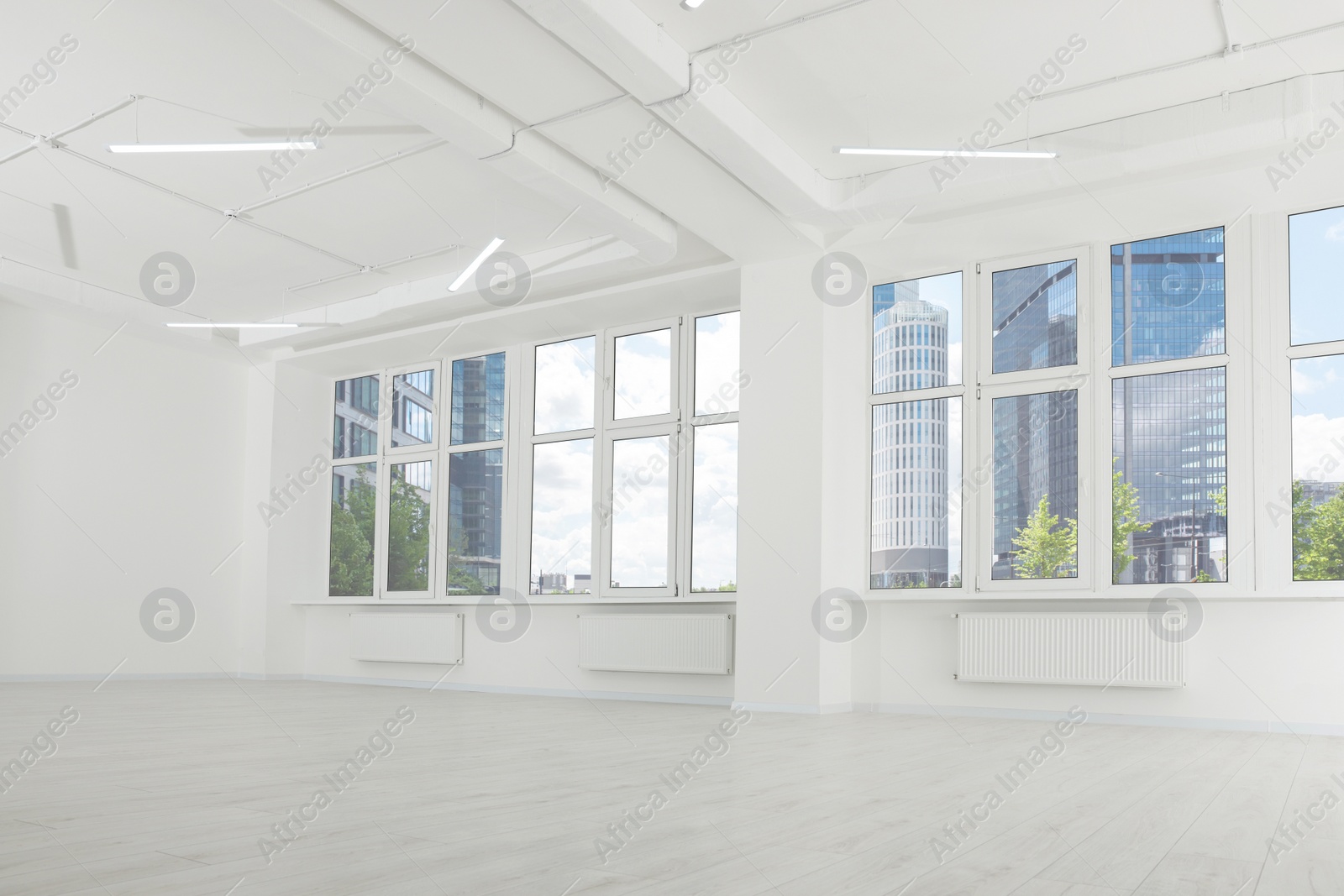 Photo of Modern office room with white walls and windows. Interior design