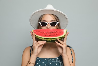 Photo of Beautiful girl with watermelon on grey background