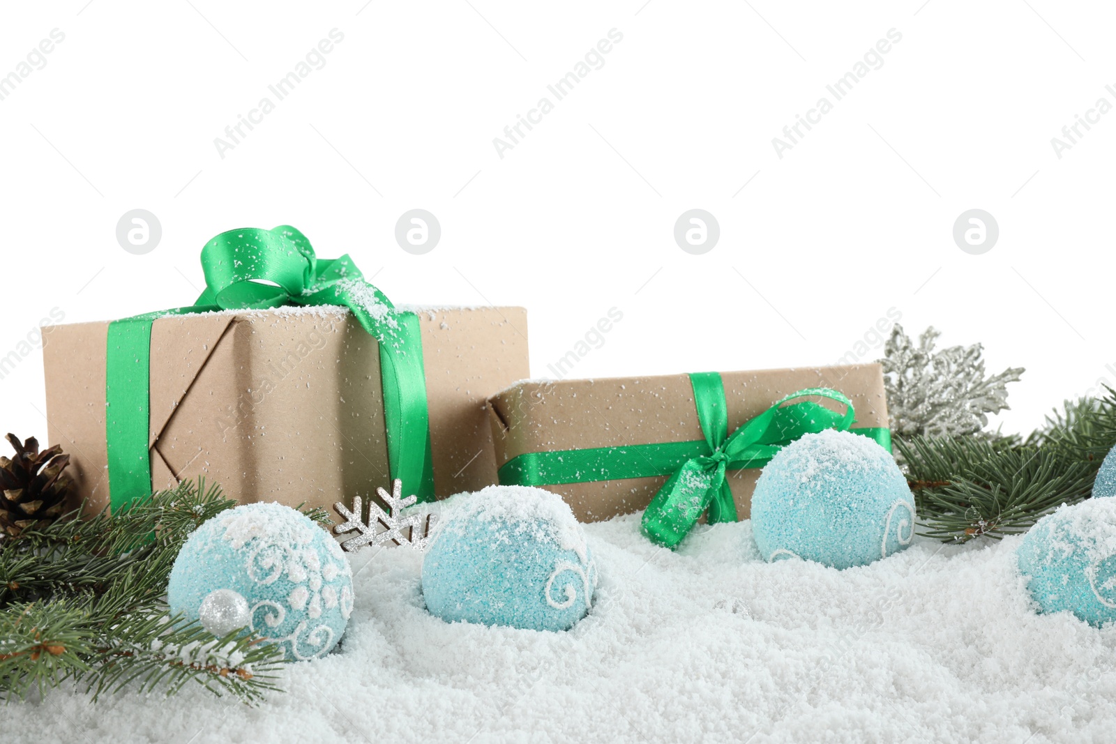 Photo of Fir branches, Christmas decoration and snow against white background