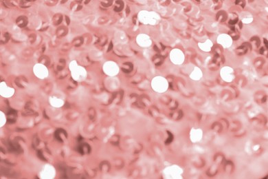 Photo of Beautiful pink fabric with shiny sequins as background, top view