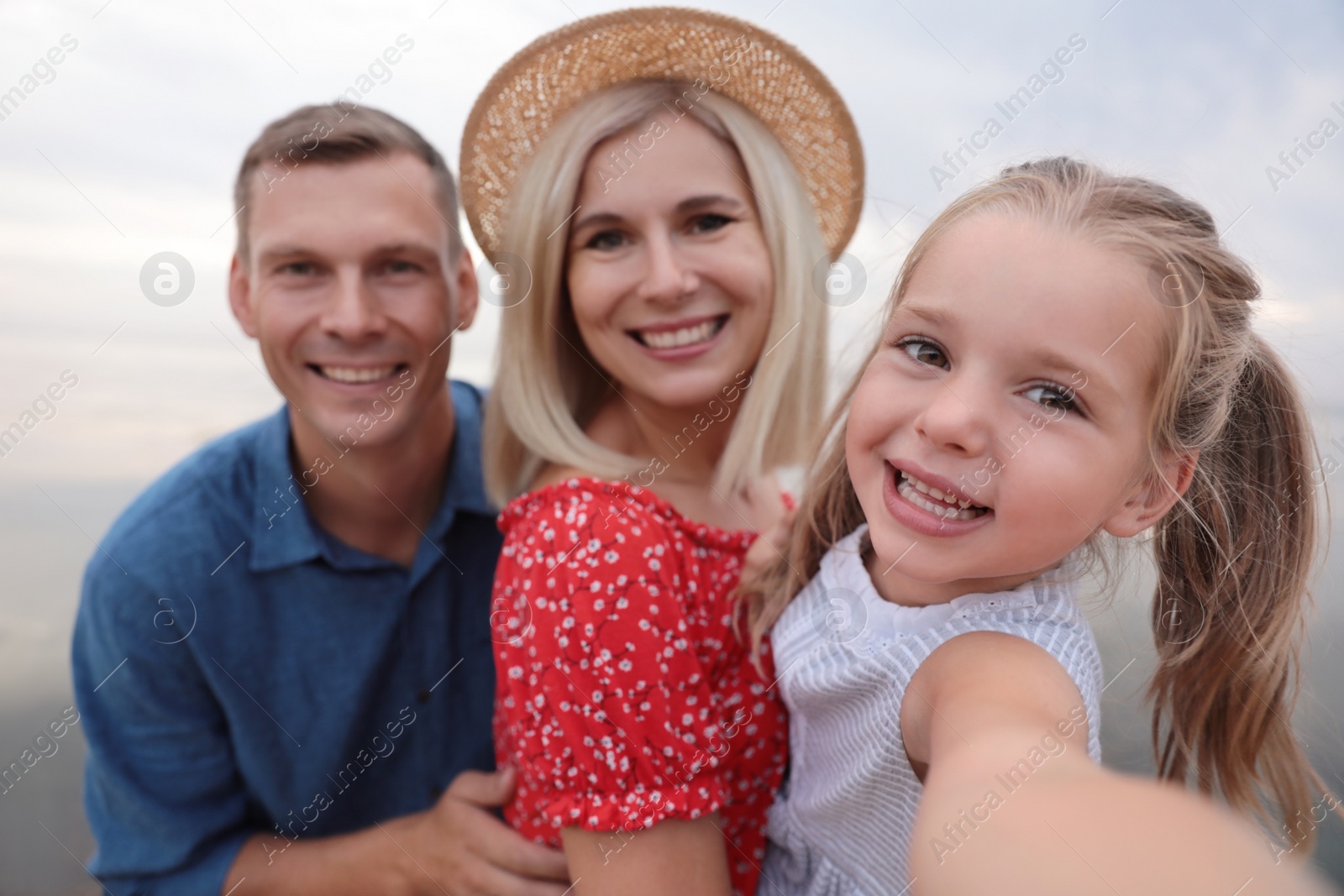 Photo of Happy family taking selfie outdoors on sunny day