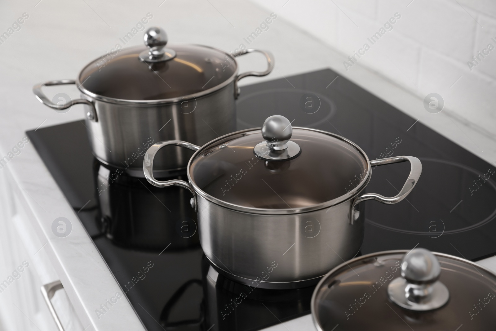 Photo of Set of new clean cookware in kitchen