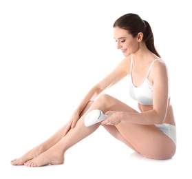 Young woman doing leg epilation procedure on white background