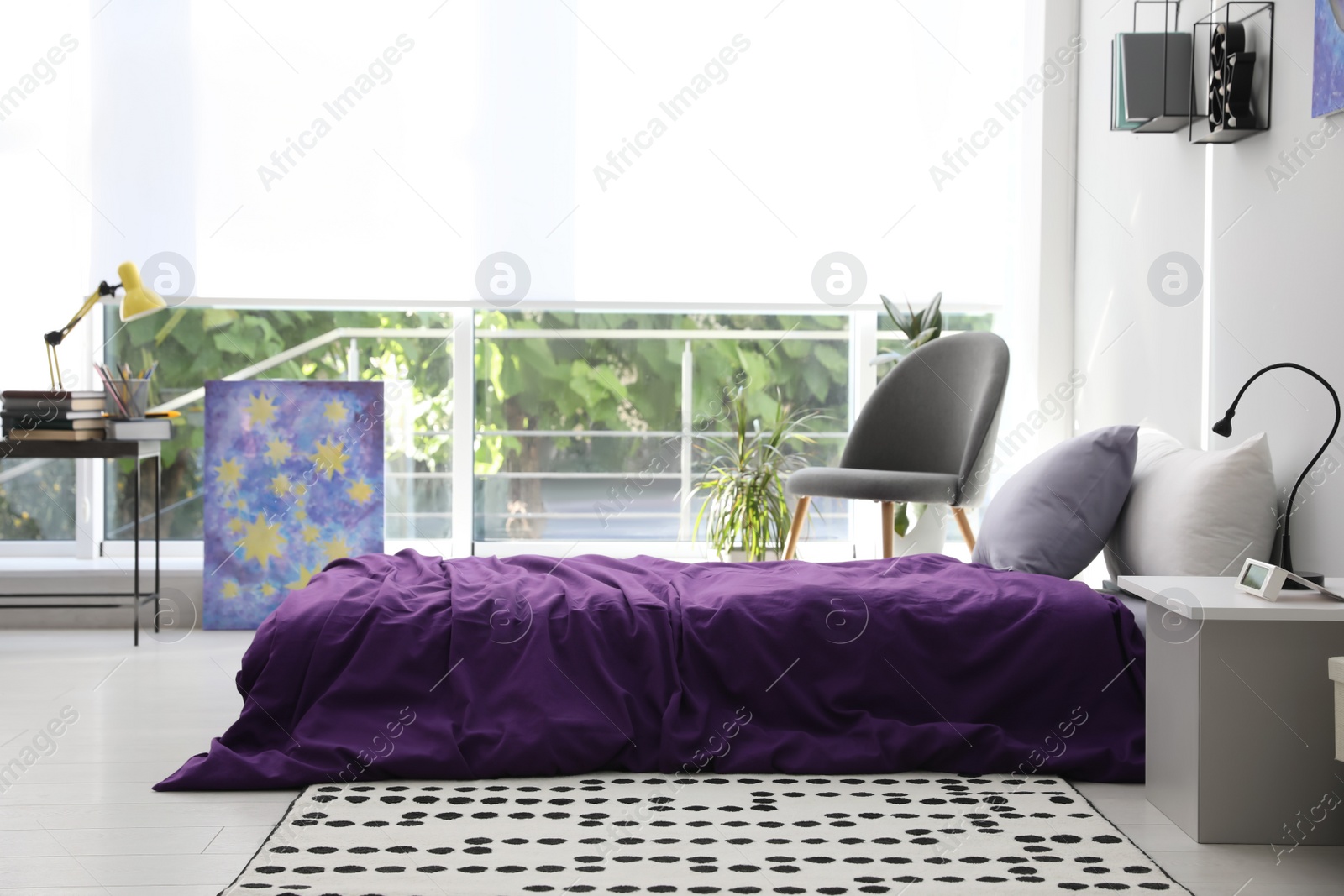 Photo of Modern teenager's room interior with comfortable bed and stylish design elements