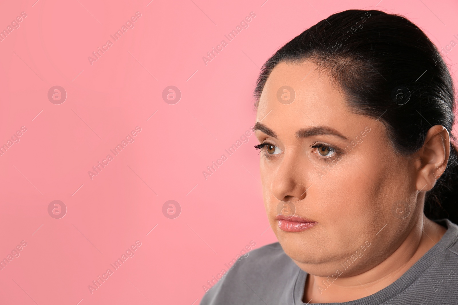 Photo of Woman with double chin on pink background. Space for text