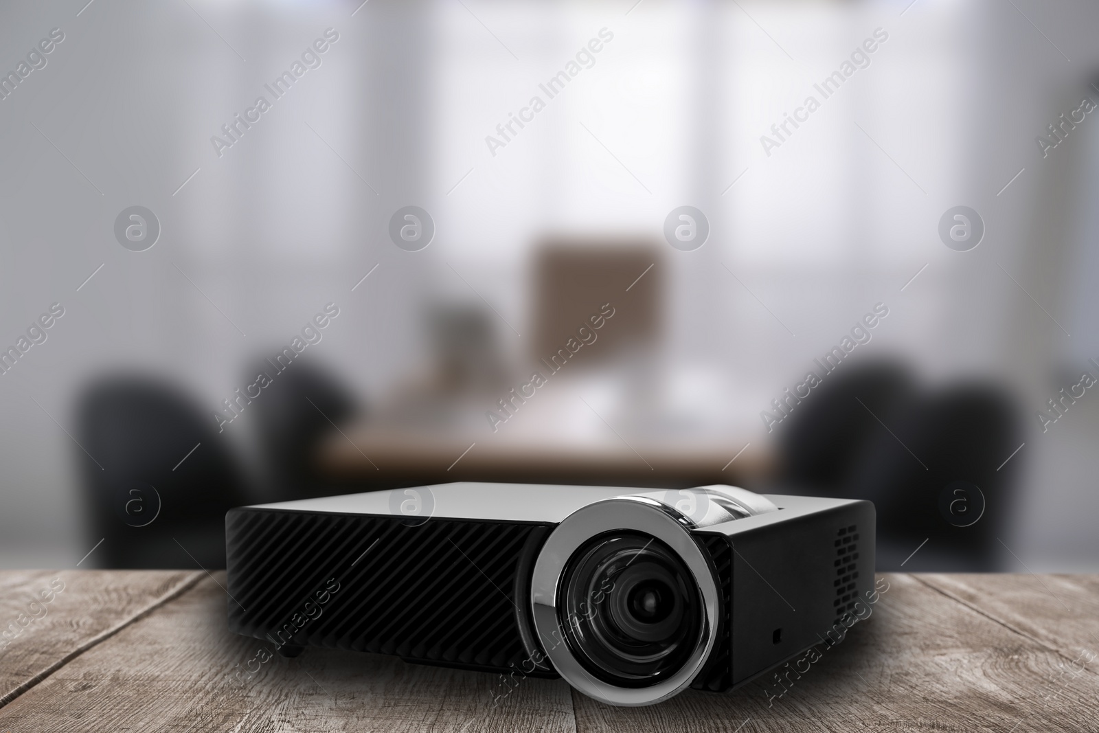 Image of Modern video projector and blurred conference room on background