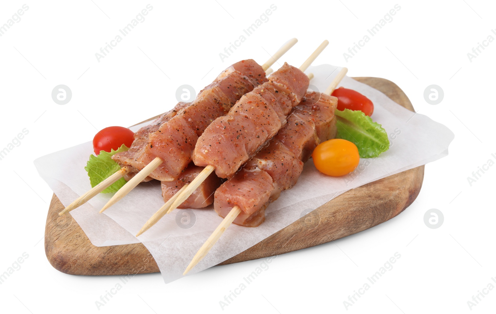 Photo of Wooden skewers with cut raw marinated meat isolated on white