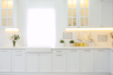 Photo of Blurred view of modern kitchen interior with stylish furniture