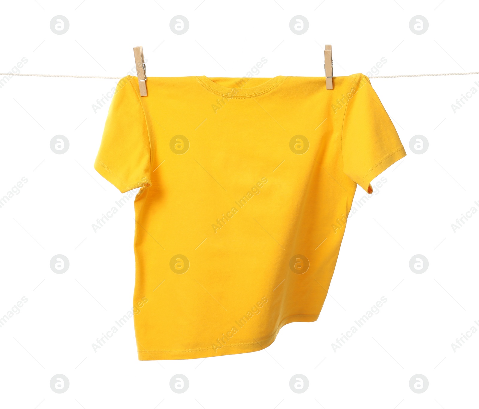 Photo of One yellow t-shirt drying on washing line isolated on white