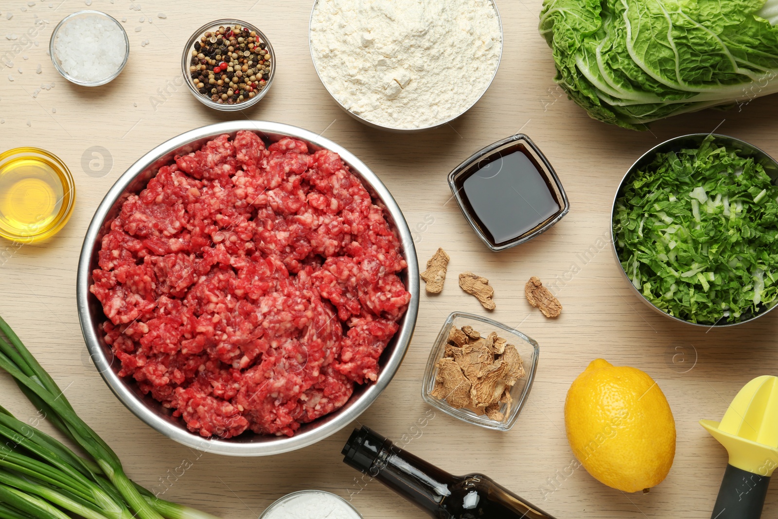 Photo of Flat lay composition with ingredients for gyoza on wooden table