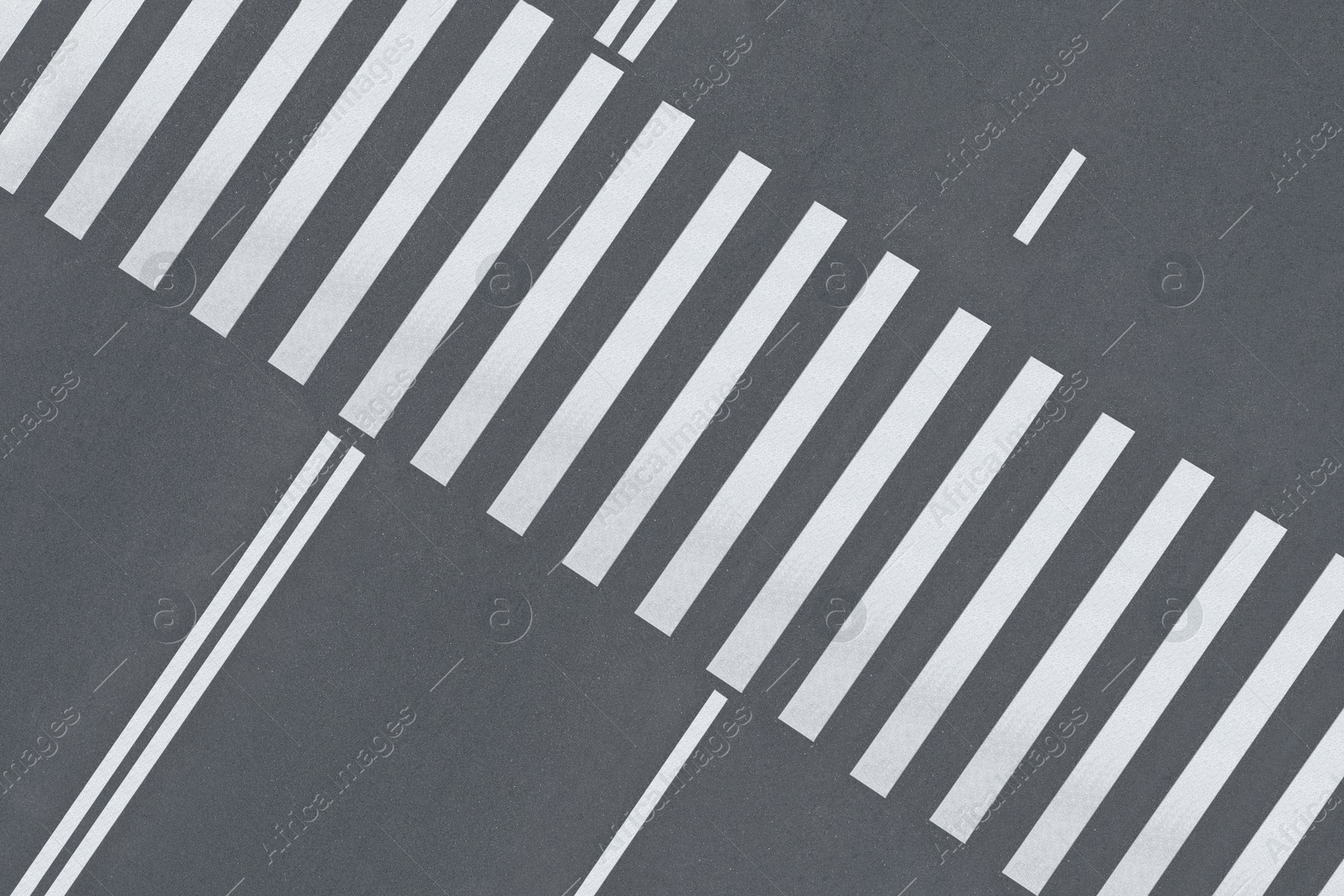 Image of White pedestrian crossing on empty city street, top view