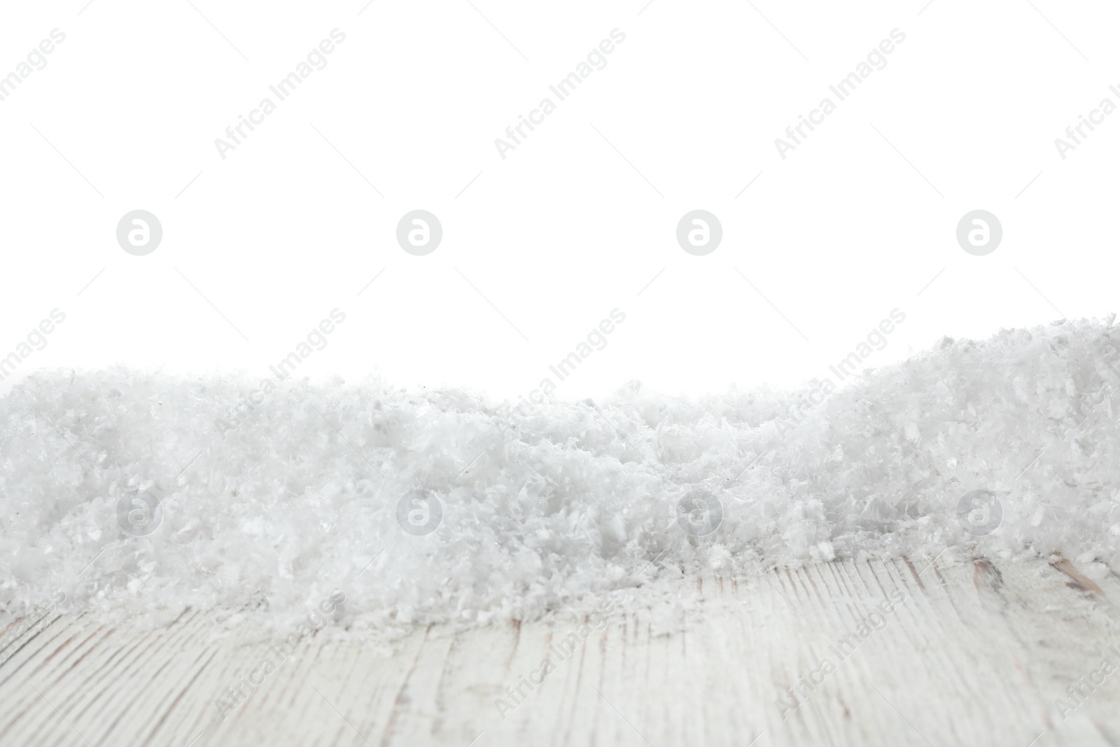 Photo of Heap of snow on wooden surface against white background. Christmas season