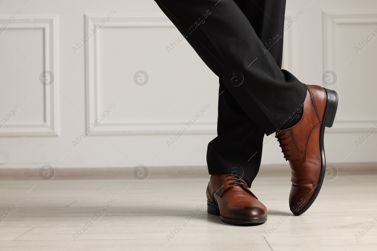 Photo of Businessman in elegant leather shoes indoors, closeup. Space for text