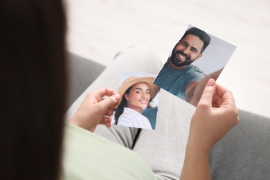 Woman holding torn photo on sofa indoors, closeup. Divorce concept