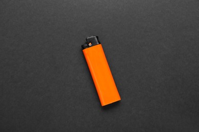 Stylish small pocket lighter on black background, top view
