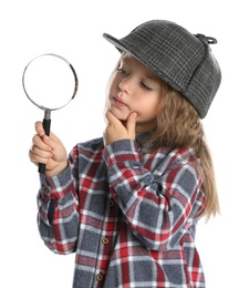 Photo of Cute little child in hat with magnifying glass playing detective on white background