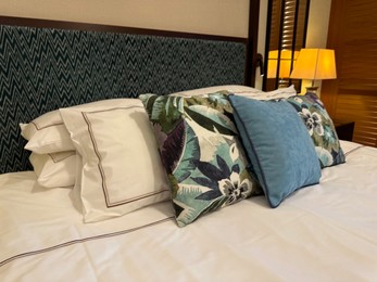 Photo of Large bed with soft pillows in hotel room