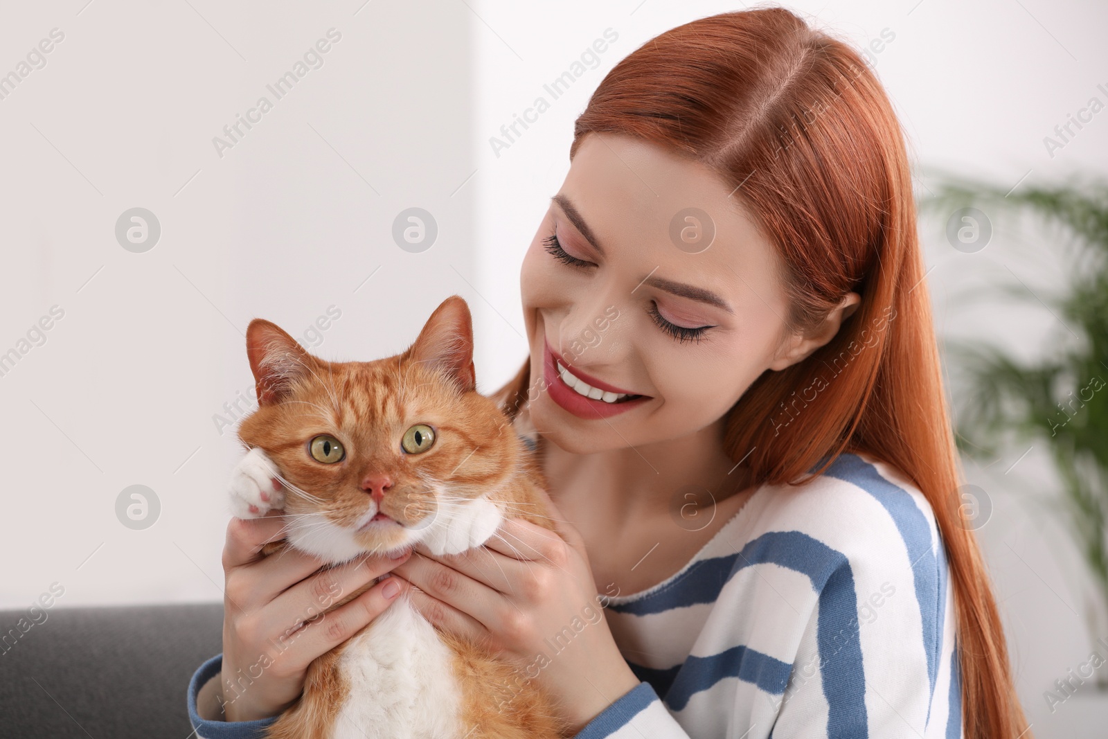 Photo of Happy woman with her cute cat at home