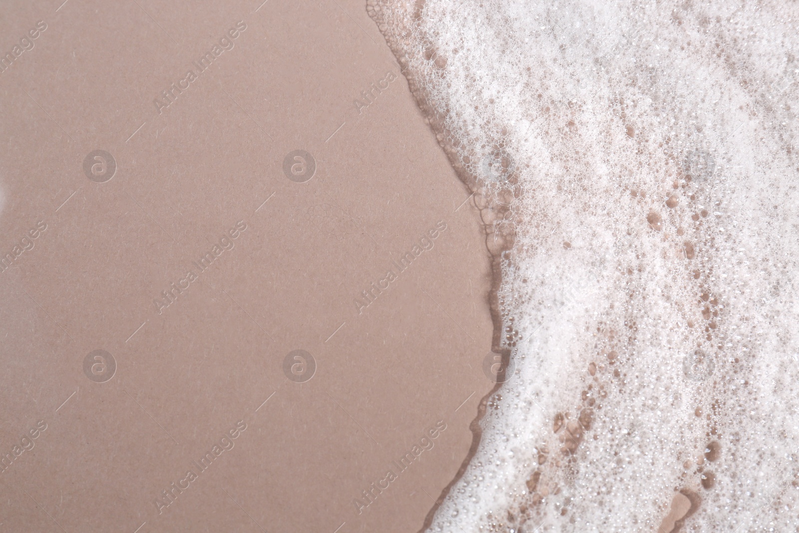 Photo of Foaming cleanser on brown background, top view and space for text. Skin care cosmetic