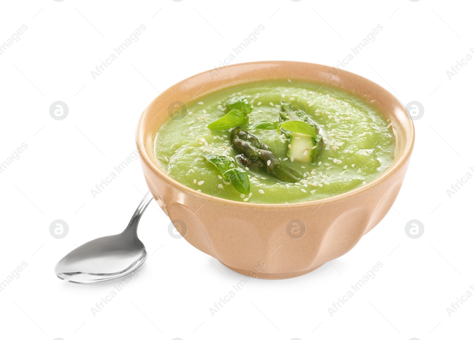 Photo of Delicious asparagus soup with basil and sesame  seeds isolated on white