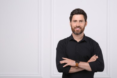Photo of Portrait of handsome man near white wall, space for text