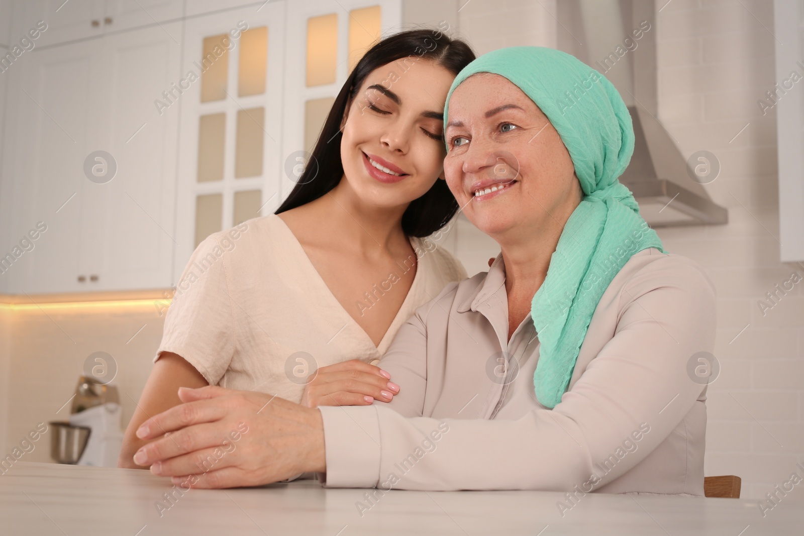 Photo of Young woman visiting her mother with cancer indoors