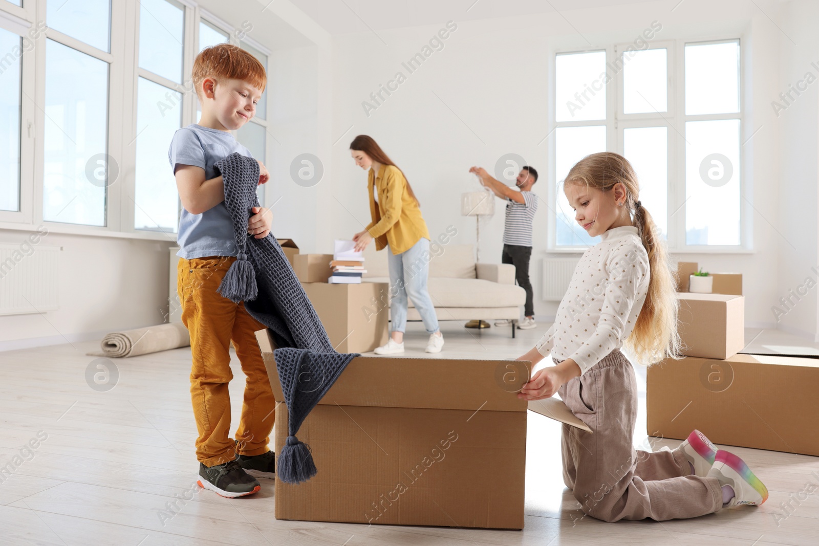 Photo of Happy family settling into new house and unpacking boxes. Moving day