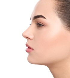 Portrait of young woman with beautiful face and natural makeup on white background, closeup