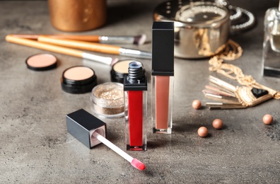 Photo of Beautiful composition with lipsticks on table. Decorative cosmetics