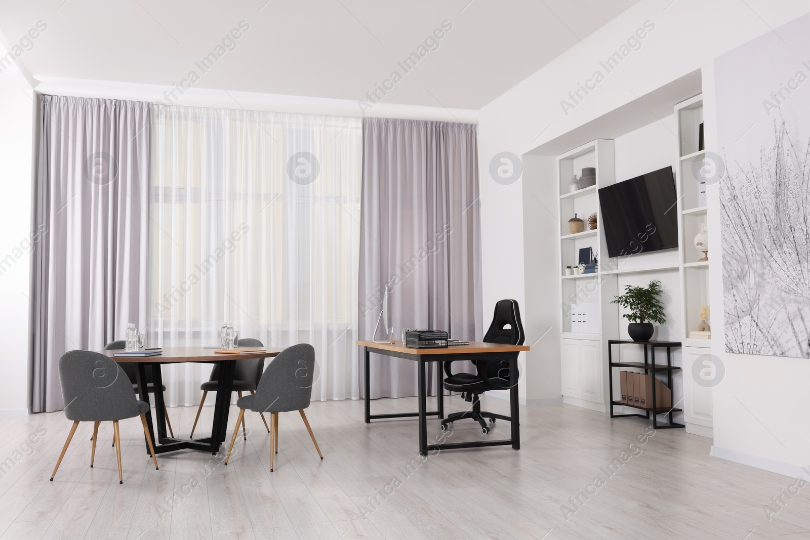 Photo of Stylish director's workplace with comfortable furniture and tv zone in room. Interior design