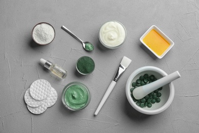 Photo of Flat lay composition with spirulina facial mask and ingredients on light grey table